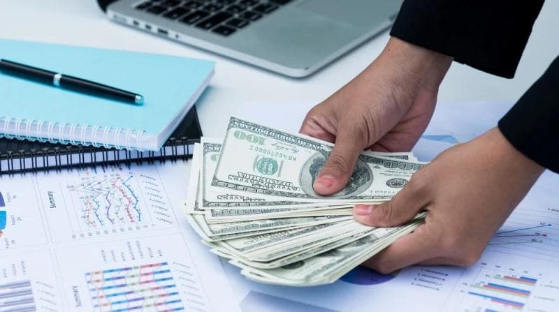 Man holding Legal Funding money