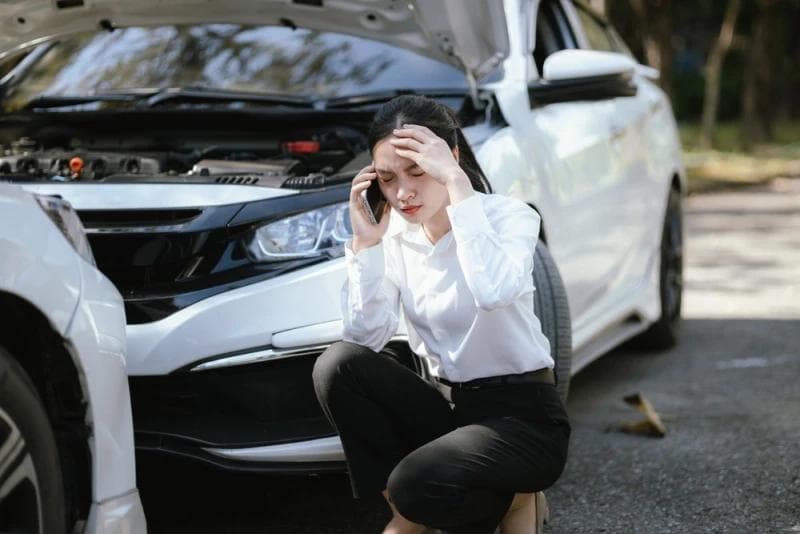Woman on the phone after car accident