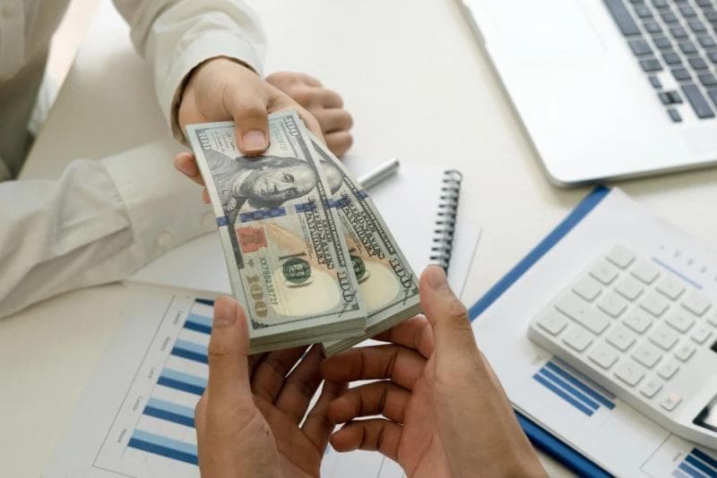 Man in shirt giving pre-settlement funding money
