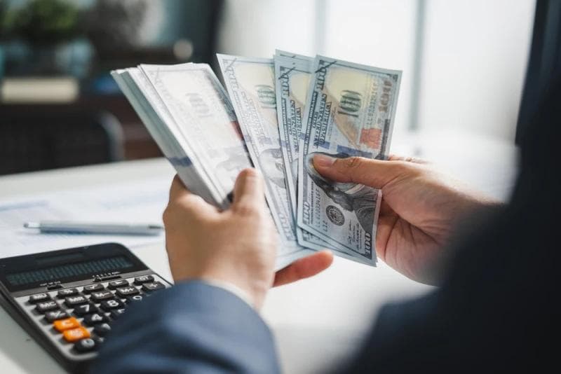 Hands of man counting pre-settlement money