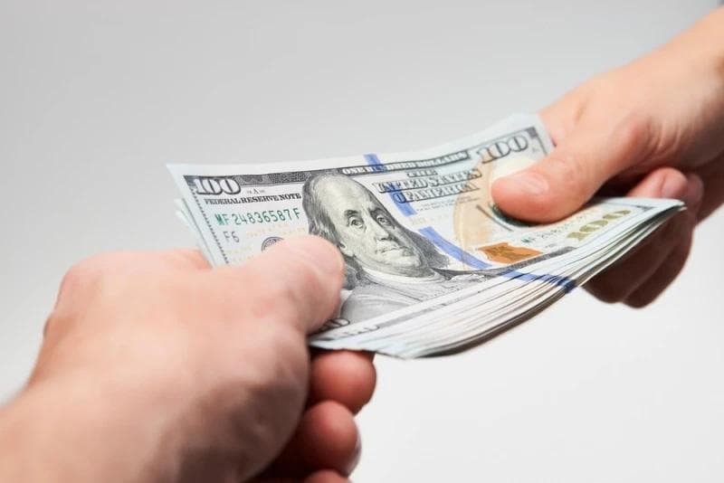 Man handing Lawsuit Loan money