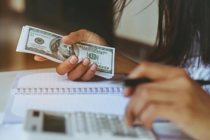 Woman holding Legal Funding money