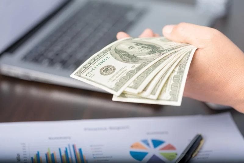 Woman holding Legal Funding money