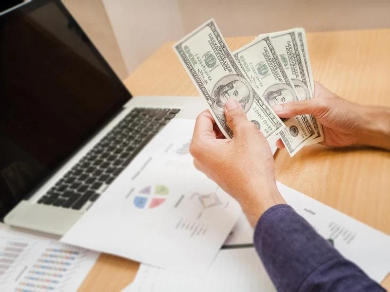 Man counting Legal Funding money