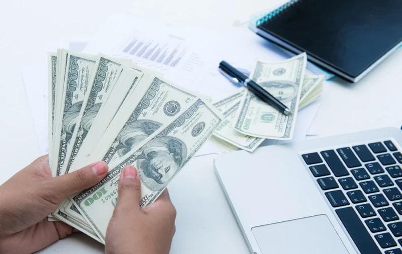 Man counting Legal Funding money