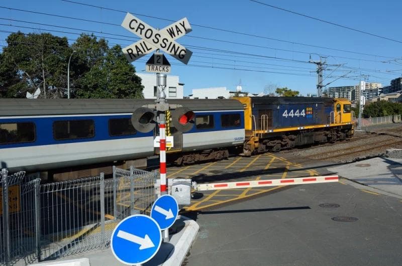 The engine and front car of a passenger train can be seen passing through an intersection at a railroad crossing. Rockpoint Legal Funding, the best lawsuit loan company, provides pre-settlement funding for plaintiffs who have been injured in train accidents.