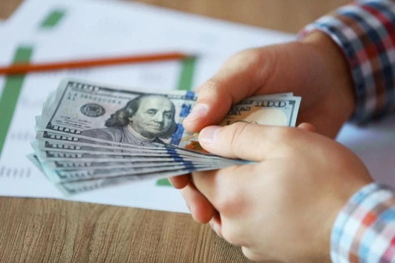 Hands holding Legal Funding money