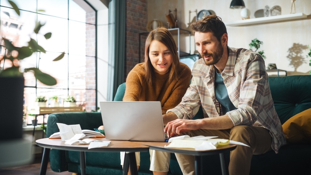 couple helping each other fill out legal funding application